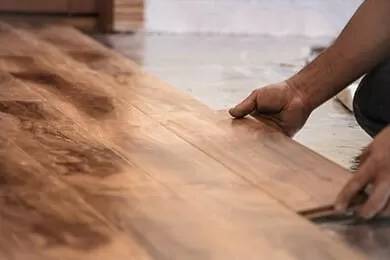 Honey Do Master Craftsman laying wood flooring